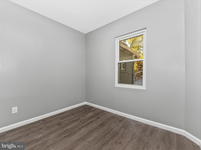 empty room with dark wood-type flooring