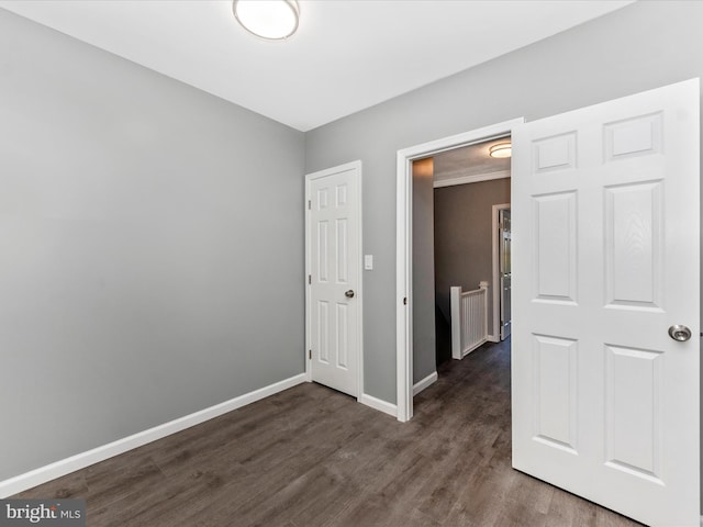 empty room with dark hardwood / wood-style flooring