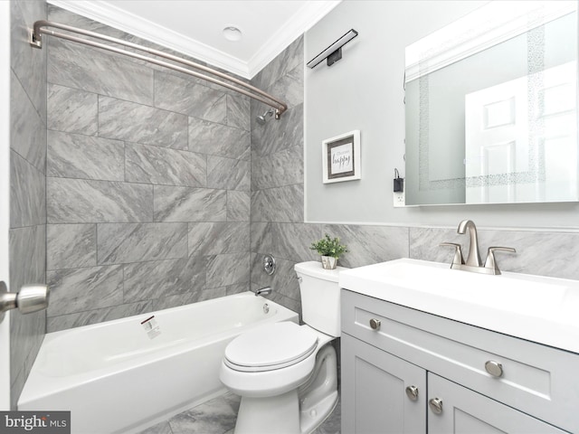 full bathroom featuring toilet, tiled shower / bath, vanity, and tile walls