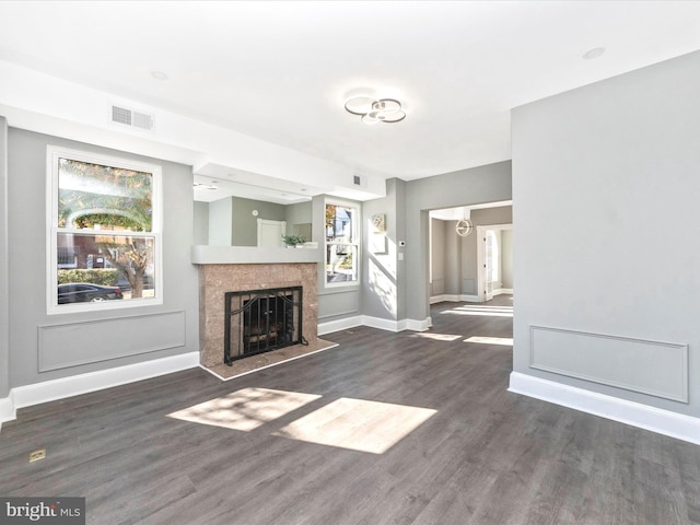 unfurnished living room with dark hardwood / wood-style flooring