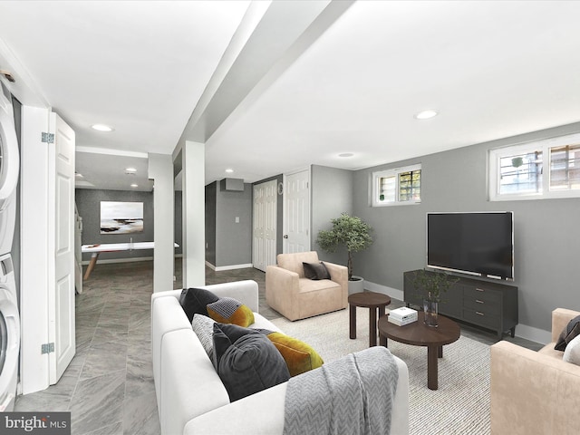 living room with stacked washer / dryer