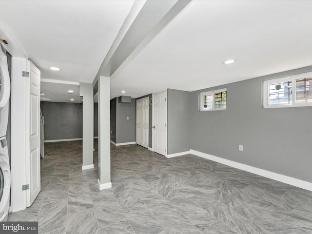 basement with stacked washer and dryer