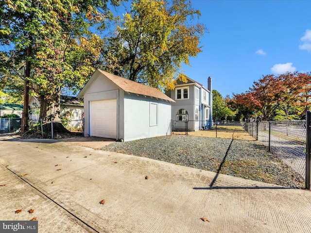 exterior space with an outbuilding and a garage