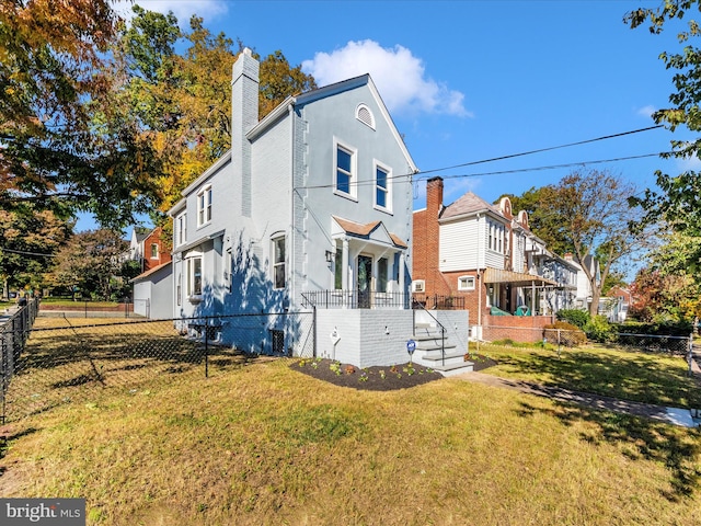 view of side of home with a yard