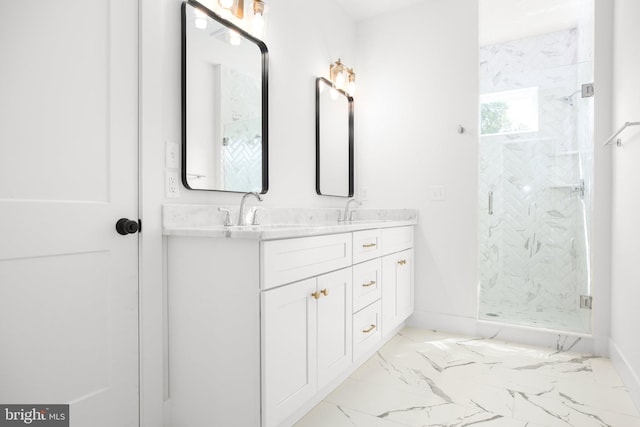 bathroom with vanity and a shower with door