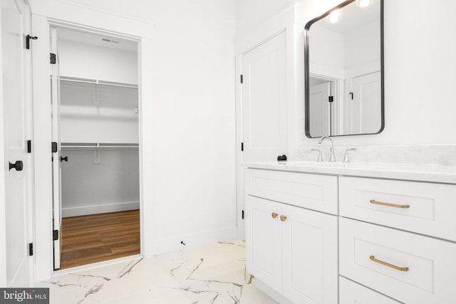 bathroom with vanity and hardwood / wood-style flooring