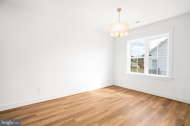 unfurnished room with wood-type flooring