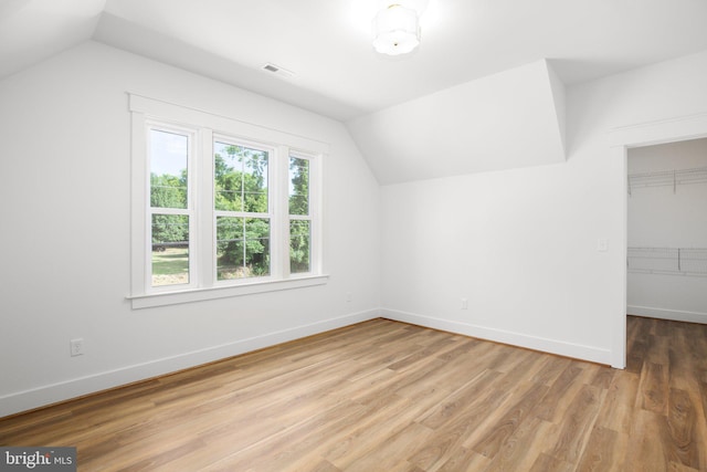 bonus room featuring lofted ceiling and hardwood / wood-style floors