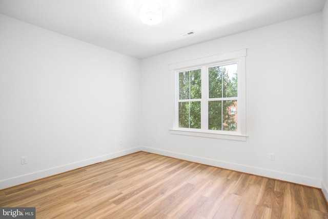 spare room with light hardwood / wood-style flooring