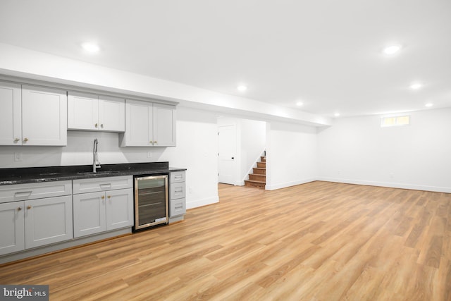 kitchen featuring light hardwood / wood-style flooring, wine cooler, sink, and gray cabinetry