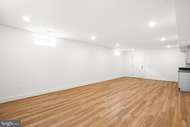 basement featuring light hardwood / wood-style floors