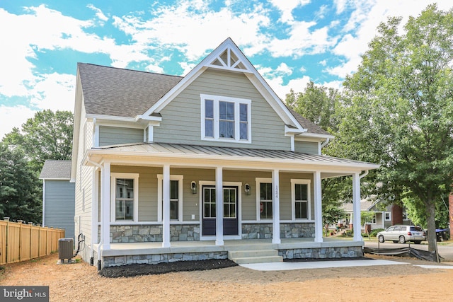 view of front of house featuring a porch and cooling unit