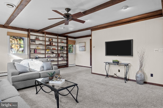 carpeted living room with beamed ceiling, ceiling fan, and a baseboard radiator