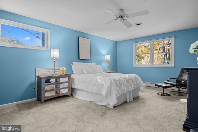 bedroom with ceiling fan and light carpet