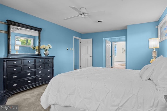 carpeted bedroom featuring connected bathroom and ceiling fan