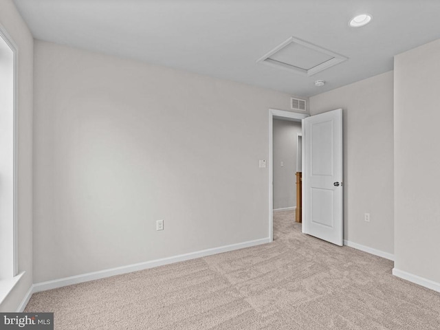 unfurnished room featuring light carpet