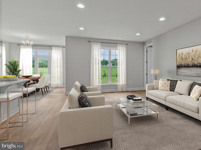 living room featuring a chandelier and light wood-type flooring