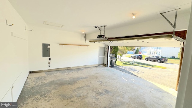 garage featuring a garage door opener and electric panel