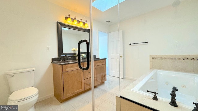 bathroom featuring tile patterned floors, toilet, tiled tub, vanity, and a skylight