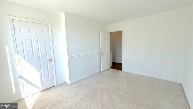 unfurnished room featuring light carpet