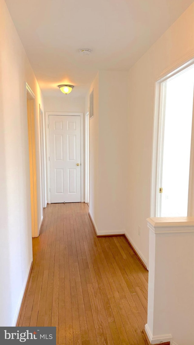 corridor with light wood-type flooring