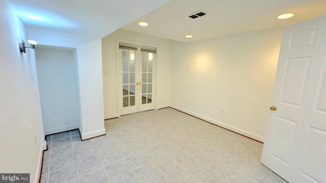 unfurnished room with french doors