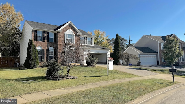 colonial inspired home featuring a front yard, a garage, and central AC unit