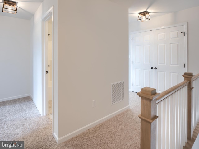 corridor featuring light carpet