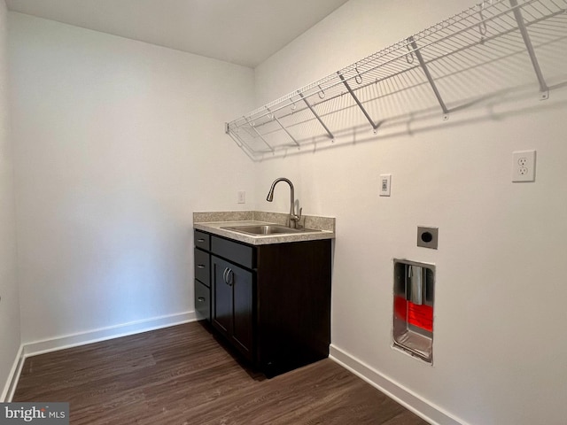 washroom with sink, dark wood-type flooring, and electric dryer hookup