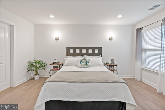 bedroom featuring wood-type flooring and multiple windows