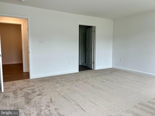 unfurnished room with light carpet