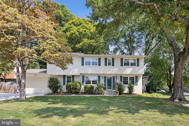 view of front of house featuring a front yard and a garage