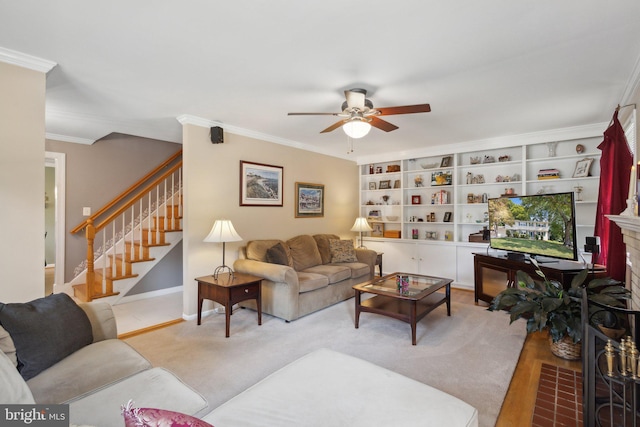 living room with ceiling fan, light hardwood / wood-style floors, ornamental molding, and a brick fireplace