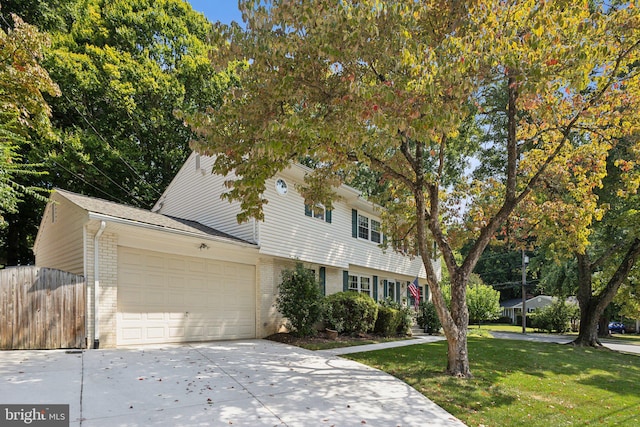 view of front of home with a front yard and a garage