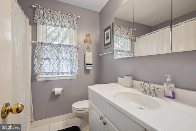 bathroom with tile patterned flooring, vanity, a notable chandelier, and toilet