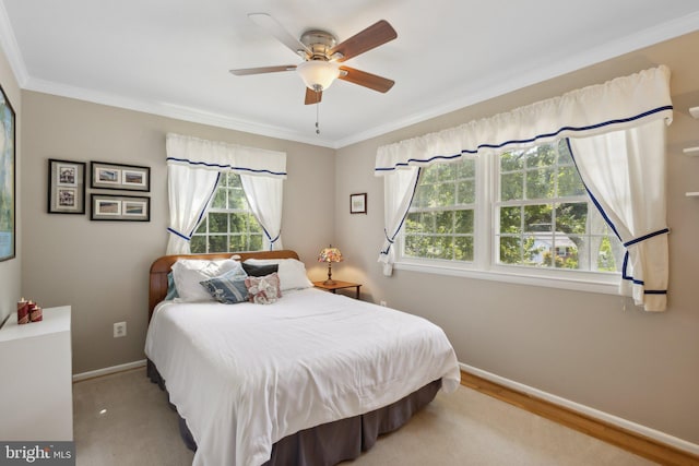 bedroom with light hardwood / wood-style flooring, ceiling fan, and crown molding