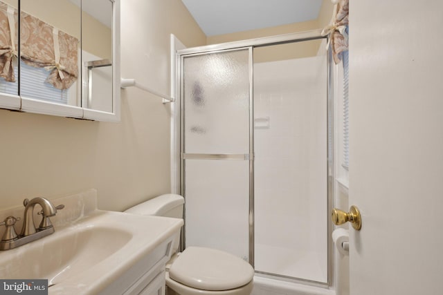 bathroom featuring walk in shower, vanity, and toilet