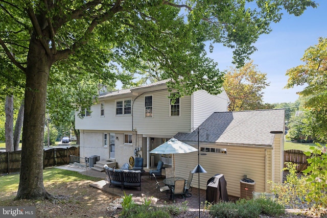 back of house with cooling unit, a patio, and an outdoor hangout area