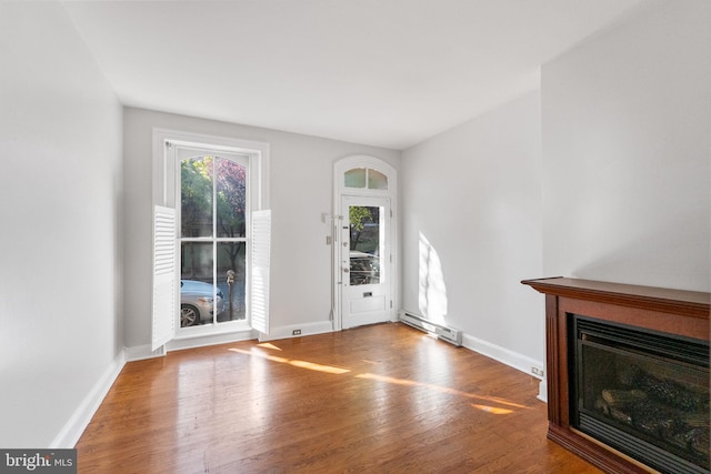 interior space with baseboard heating and hardwood / wood-style floors