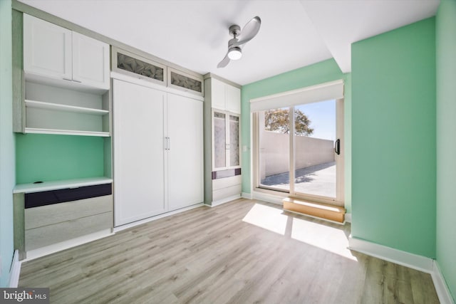 unfurnished bedroom featuring ceiling fan, a closet, and light hardwood / wood-style flooring