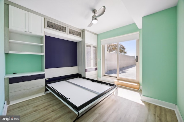 unfurnished bedroom with hardwood / wood-style floors and ceiling fan