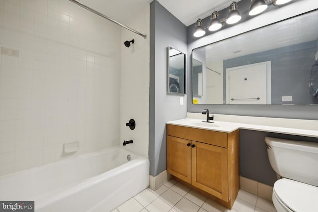 full bathroom featuring tile patterned flooring, tiled shower / bath combo, toilet, and vanity