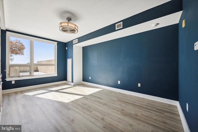 spare room with light hardwood / wood-style flooring