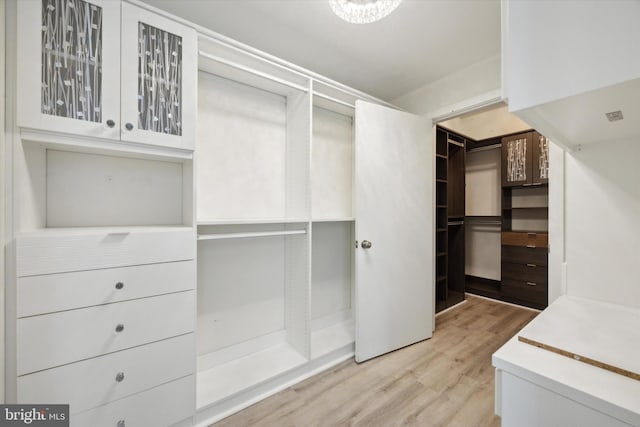 spacious closet featuring light hardwood / wood-style floors