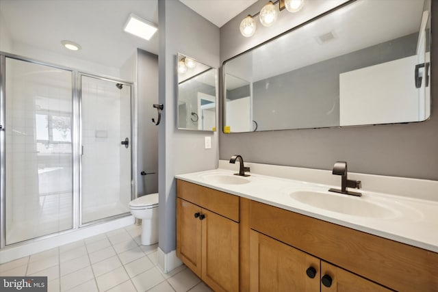 bathroom with toilet, vanity, tile patterned floors, and walk in shower