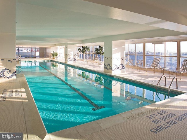 view of pool with a water view