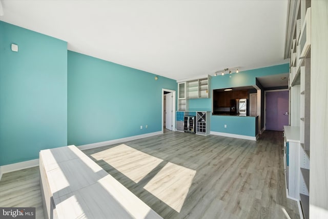 unfurnished living room with light hardwood / wood-style flooring