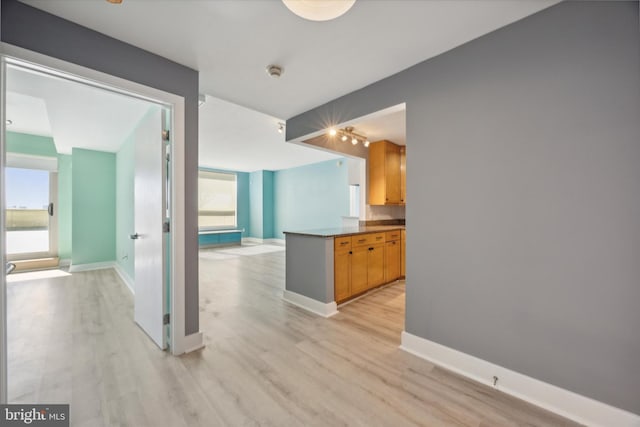 kitchen featuring kitchen peninsula and light hardwood / wood-style floors