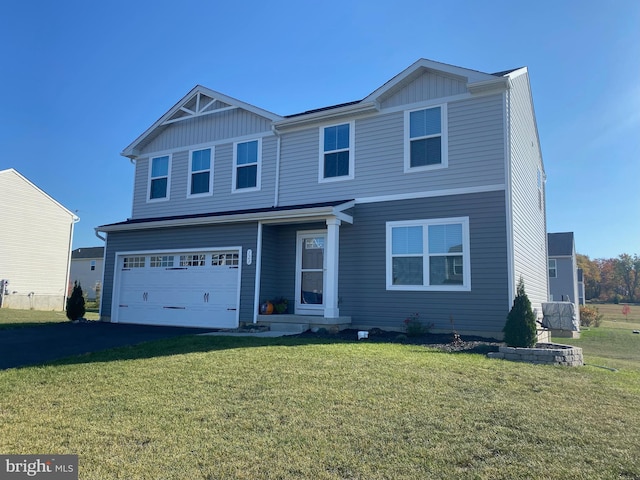 view of front of house with a garage and a front lawn