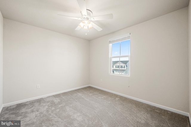 carpeted empty room featuring ceiling fan